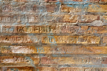 Brick Wall With Carved In Names. Rich Texture For Background, Wallpaper Etc.  Pattern Frontal Square Straight On.
