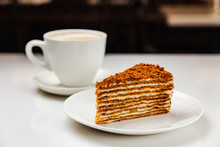 Traditional delicious honey cake and a cup of coffee