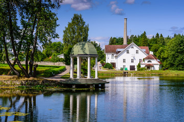 Wall Mural - Sightseeing of Estonia. Palmse manor (Palmse möis) museum in Lahemaa National Park. Beautiful summer landscape. A picturesque Park with a pond.