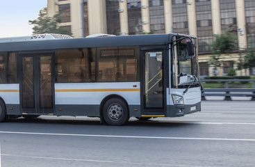 Canvas Print - bus rides along the street in the city