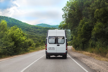 Wall Mural - Minibus rides on a mountain road