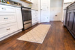 New construction modern kitchen with white cabinets and hardwood floors