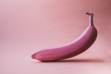 pink banana on pink background, color background, made with fresh banana fruit, minimal concept, pattern