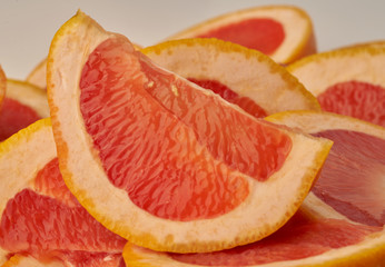 Grapefruit web banner background. Pile of fresh cut grapefruits. Fruits summer bright concept