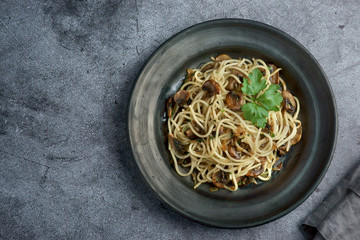 Wall Mural - spaghetti with mushrooms on a dark background