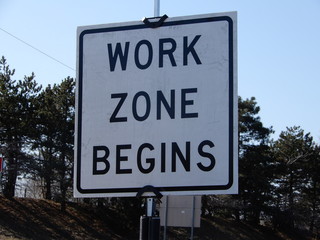 Closeup Workzone Construction Sign Against Tree Background