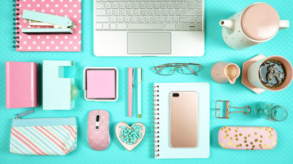 Canvas Print - Desktop workspace flat lay with hi-tech touch screen laptop and modern pink and aqua blue accessories on blue background