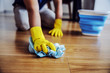 © Dusan Petkovic - Close up of man waxing parquet. Selective focus on hand with cloth. Rubber gloves on hands. Home interior.