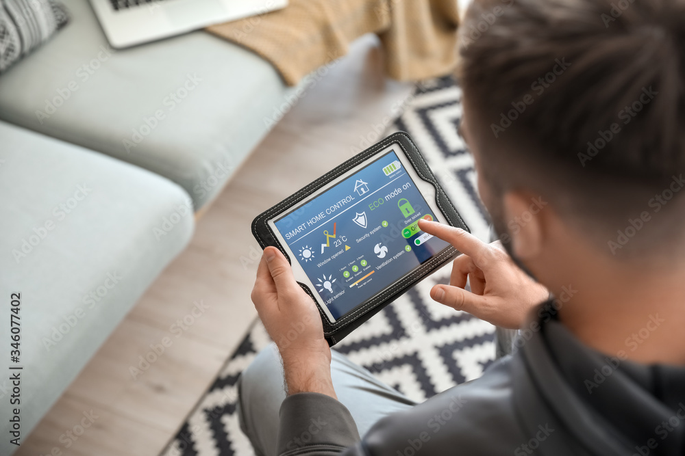 Man using application of smart home automation