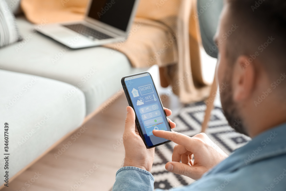 Man using application of smart home automation