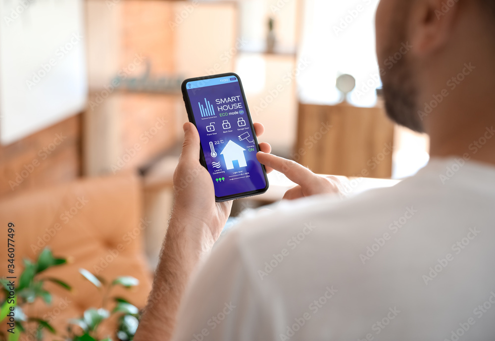 Man using application of smart home automation