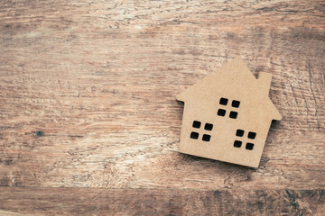 Wall Mural - Model house on wooden background.investment insurance and home purchase mortgage concept