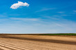 © marcin jucha - Plowed or Ploughed Fields in Countryside. Organic Food and Agriculture. Blue Sky over Horizon