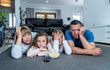 © SB Arts Media - COVID 19 Outbreak. Bored and frustrated family watching tv at home feeling depressed  Mental health Impact of lockdown social distancing and Job losses due to coronavirus.