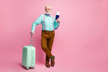 Sticker - Full size photo of cool modern old grey hair man want go rest hold trolley documents wear teal turquoise shirt brown trousers suspenders footwear isolated pastel pink color background