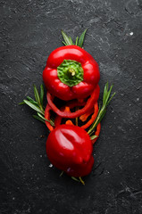 Red bell pepper on a black stone background. Free space for your text.