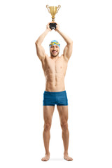 Canvas Print - Athletic male swimmer lifting a gold trophy cup