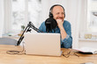 © contrastwerkstatt - Man recording a podcast with a happy smile