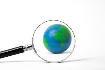 earth with magnifying glass on white background