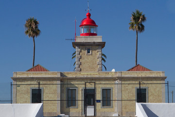 Sailor lighthouse lit at sunset