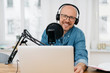 © contrastwerkstatt - Happy friendly man recording a podcast
