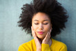 © mimagephotos - Close up beautiful young african american woman with eyes closed and hand on face