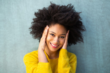 Wall Mural - horizontal portrait happy young black woman smiling with hands on face