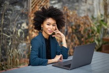 Smiling African American Businesswoman Sitting With Laptop Computer