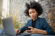 © mimagephotos - Close up businesswoman sitting with laptop computer and cellphone
