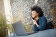 © mimagephotos - Close up happy business woman working with laptop computer and mobile phone