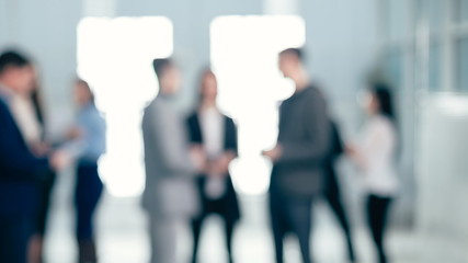 background image of a group of corporate employees in the office lobby