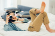 © shevchukandrey - Casual style at home and taking photos while lying on the bed