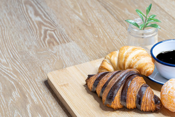 Cup of black coffee espresso and croissants