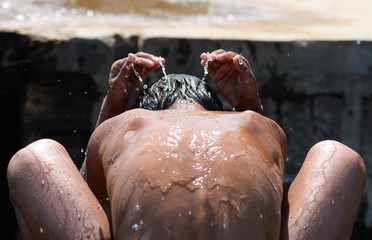 Boy bathing near a river