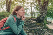 © Bits and Splits - Female hiker resting and contemplating in forest