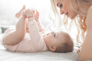 Young mother with little baby. Mommy holding her cute child. Maternity concept.