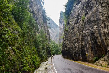 River along Bicaz Gorge road in Romania, is one of the most spectacular drives in country, location in Carpathian mountain. The high cliffs of gorge are divided by the mountain river Bicaz.