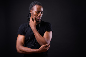 Wall Mural - Portrait of young handsome African man with dreadlocks