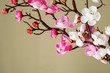 Artificial cherry blossom branch with bright pink flowers.