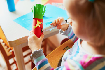 Making funny creatures from toilet paper roll tube and colorful paper