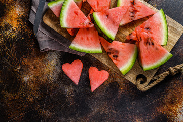 Wall Mural - Slices of ripe watermelon in the shape of a heart. The concept of love for watermelon. Selective focus
