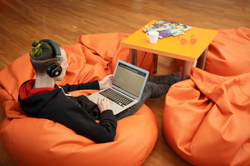 A young man works at a computer.