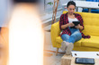 © as-artmedia - Woman taking business rest break reading business news from tablet in comfortable position at modern co work space.