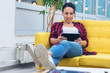© as-artmedia - Woman taking business rest break reading business news from tablet in comfortable position at modern co work space.