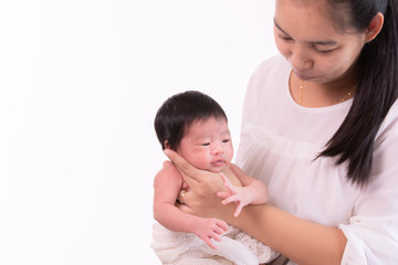 Beautiful young Asian mother hold tiny adorable newborn baby girl 0-1 month with her hand to help baby belch or Making burp after feeding with caring and love, lifestyle health care newborn at home