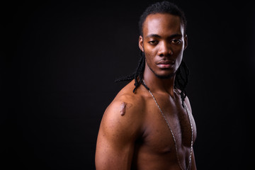 Wall Mural - Face of young handsome muscular African man with dreadlocks shirtless