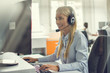 © Bojan - Professional helpline call center agent operator woman wearing headset working in customer care support centre.