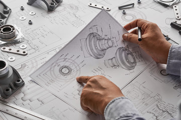 Fototapete - Engineer technician designing drawings mechanical parts engineering Engine.manufacturing factory Industry Industrial work project blueprints measuring bearings caliper tools