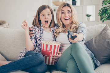 Poster - Photo of funny shocked lady mom daughter sit sofa hugging eat popcorn switch on tv set watch movie open mouth intrigue moment stay home quarantine together best friends living room indoor