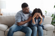 © Prostock-studio - Supportive black man comforting his upset girlfriend at home, expressing empathy